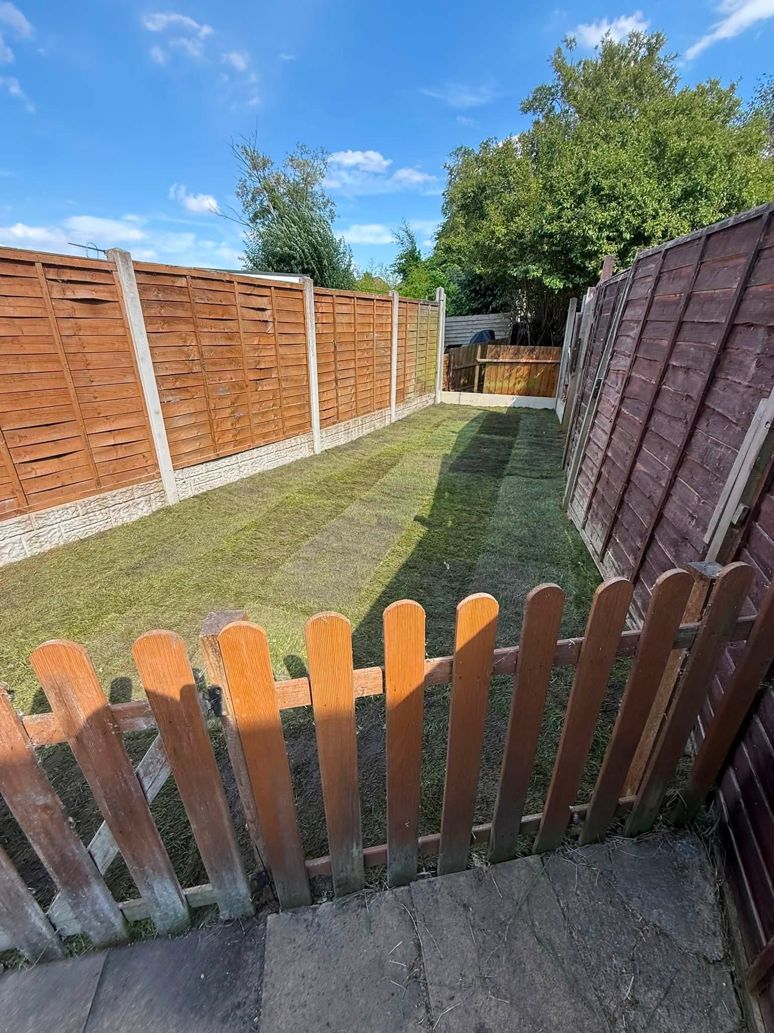 Cleared residential garden finished with a freshly laid lawn by JKS